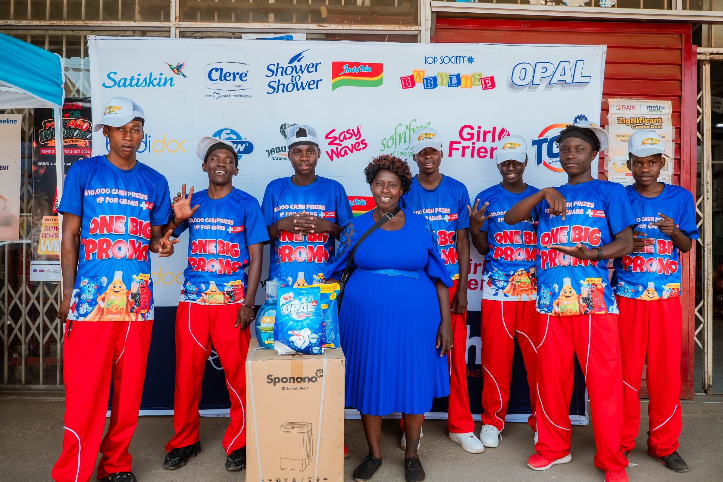 Opal promoters lined up behind the ONE BIG PROMO prize display