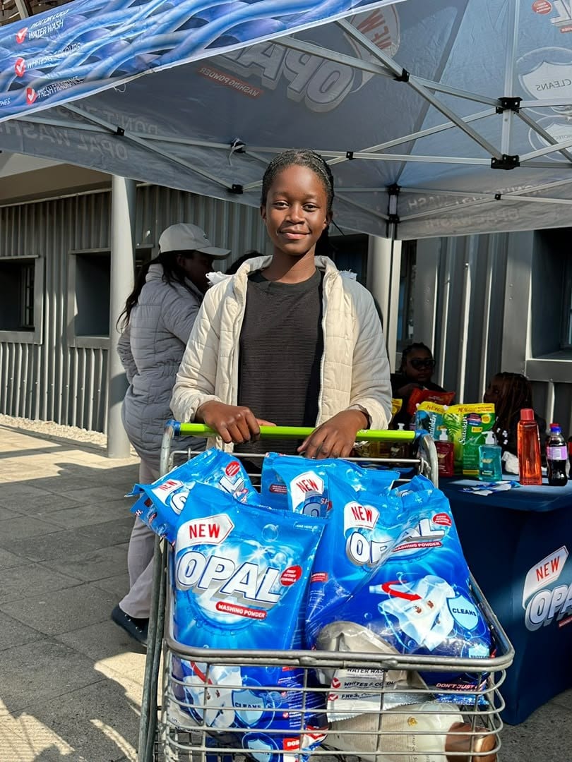 A shopper with a trolley loaded with Opal packs at a branded stand